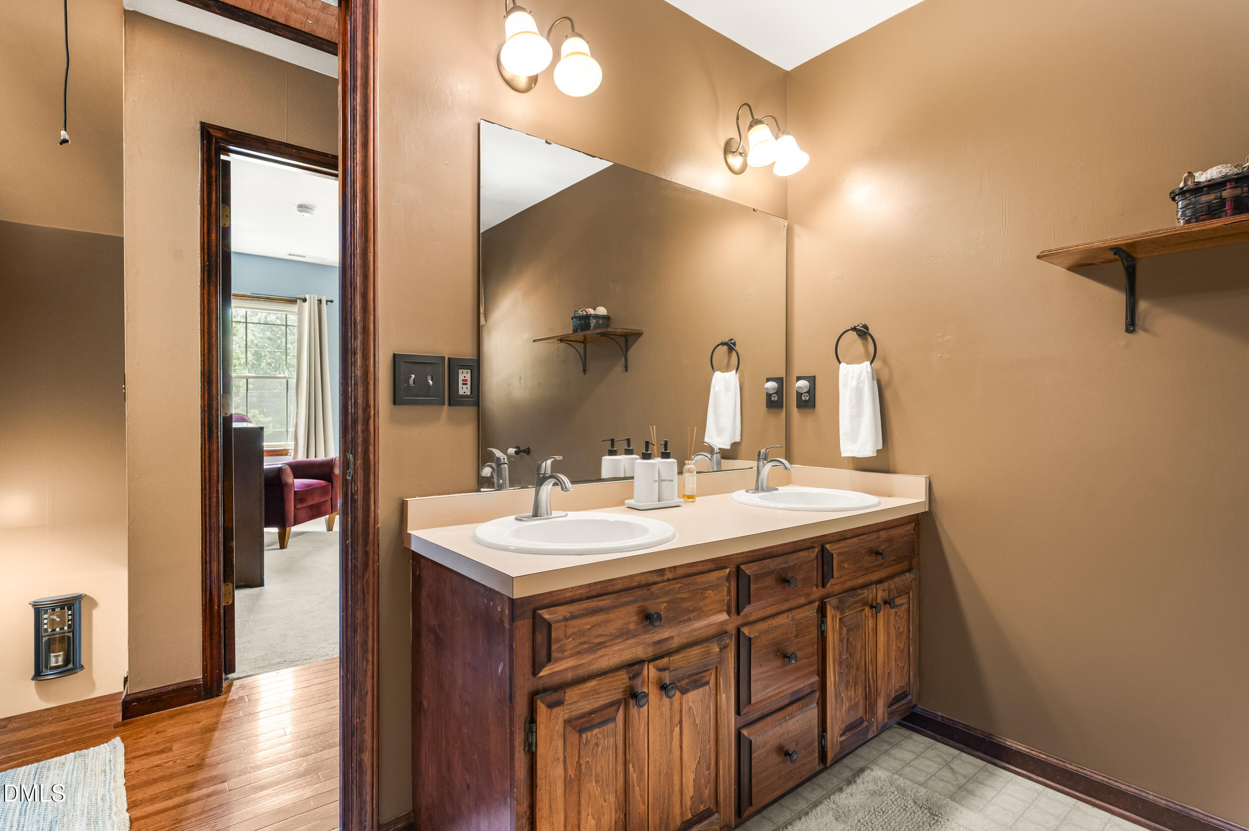4209 Lassiter Road Wake Forest, NC 27587 - Photo 35 of 39 a bathroom with a double vanity sink and a mirror