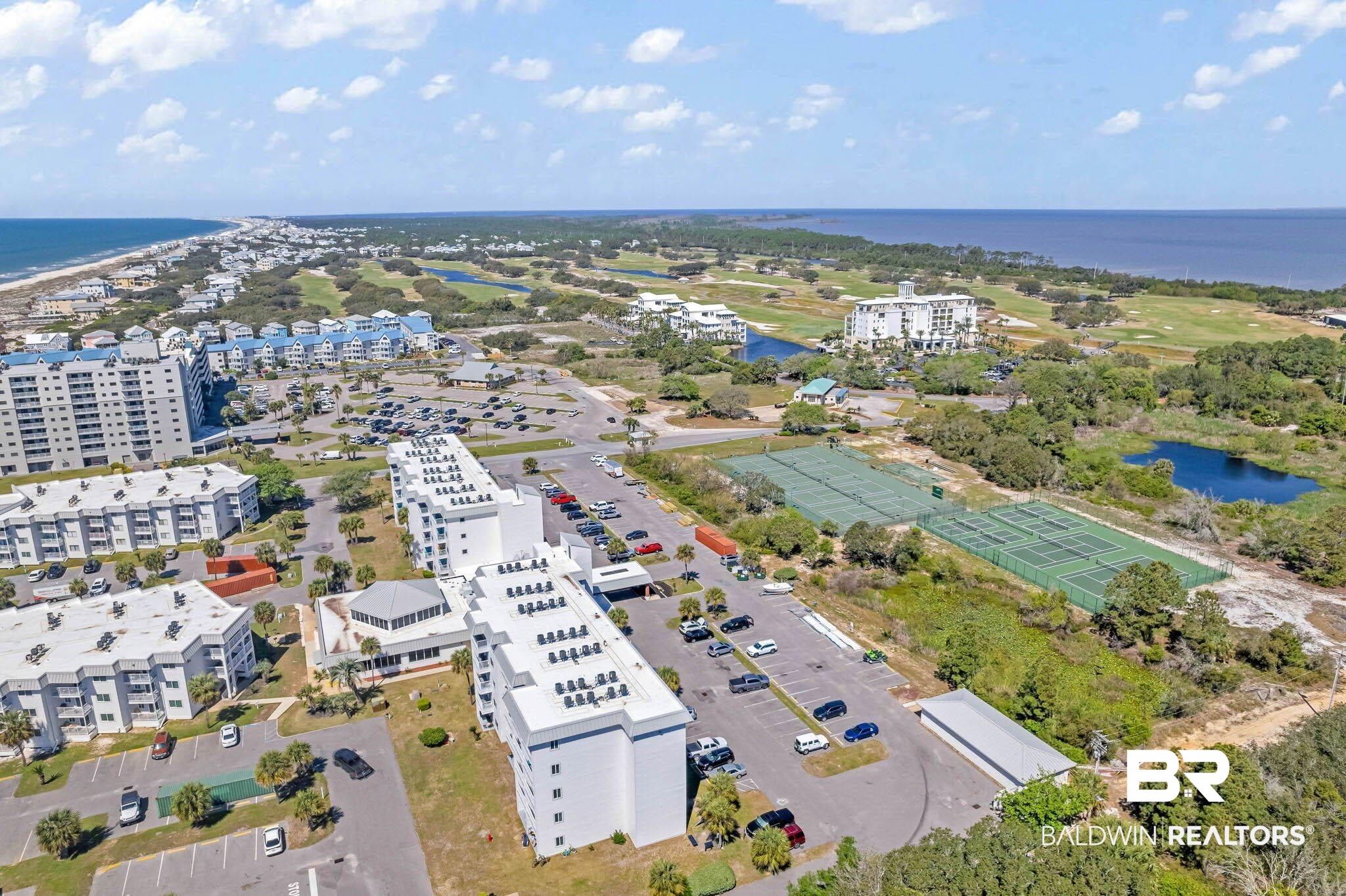400 Plantation Road, Unit 4501 Gulf Shores, AL 36542 - Photo 18 of 30 Aerial perspective showcasing multiple residential buildings, expansive paved parking areas, and abundant green spaces