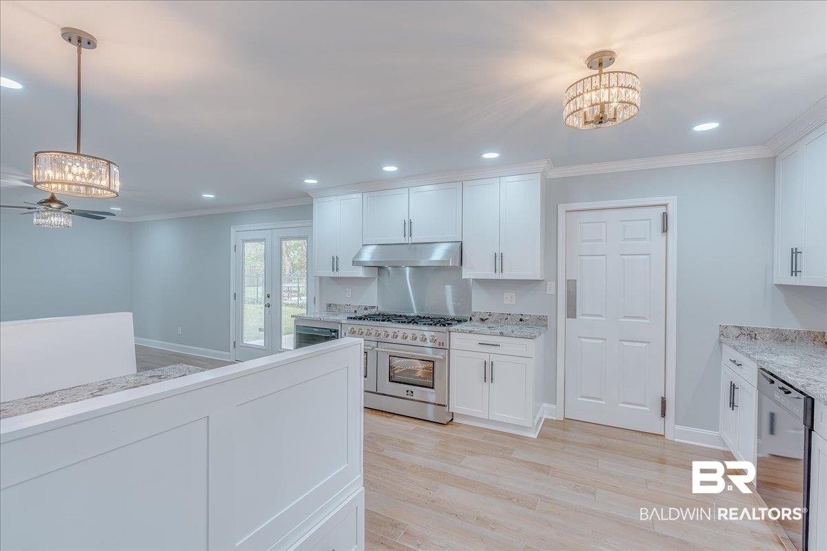 440 Dykes Road Mobile, AL 36608 - Photo 8 of 49 Kitchen with under cabinet range hood, dishwasher, stainless steel stove, and ornamental molding