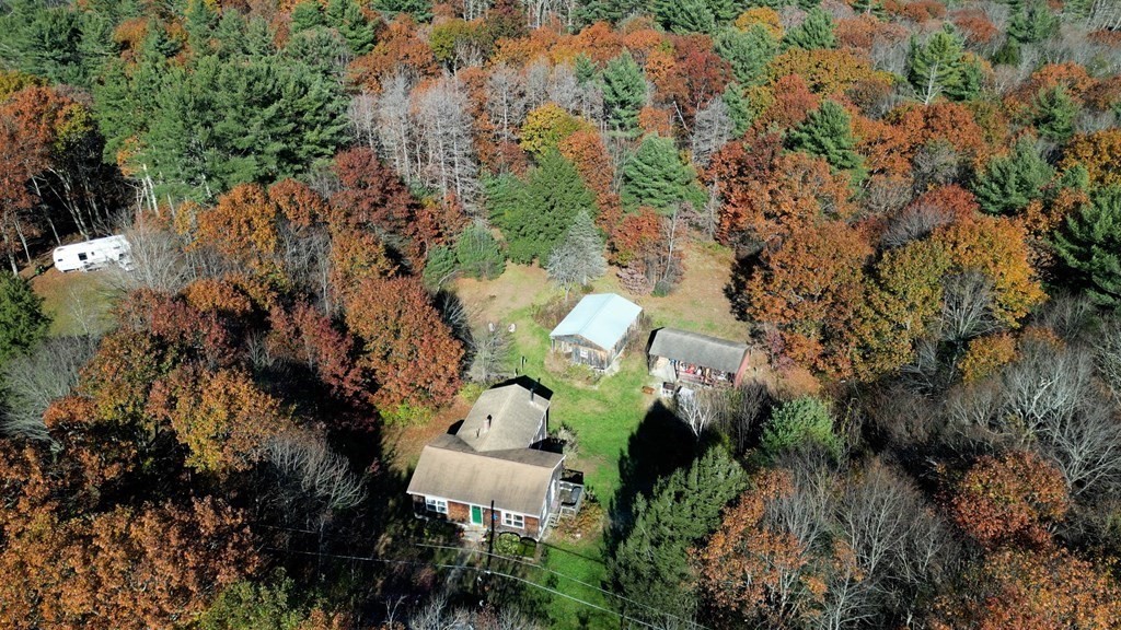 a view of a house with a yard and sitting area