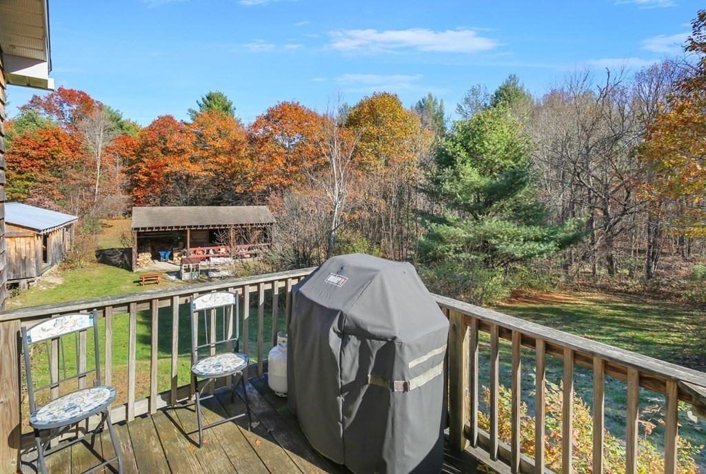 27 Locke Road Rutland, MA 01543 - Photo 24 of 39 a balcony with wooden floor table and chairs