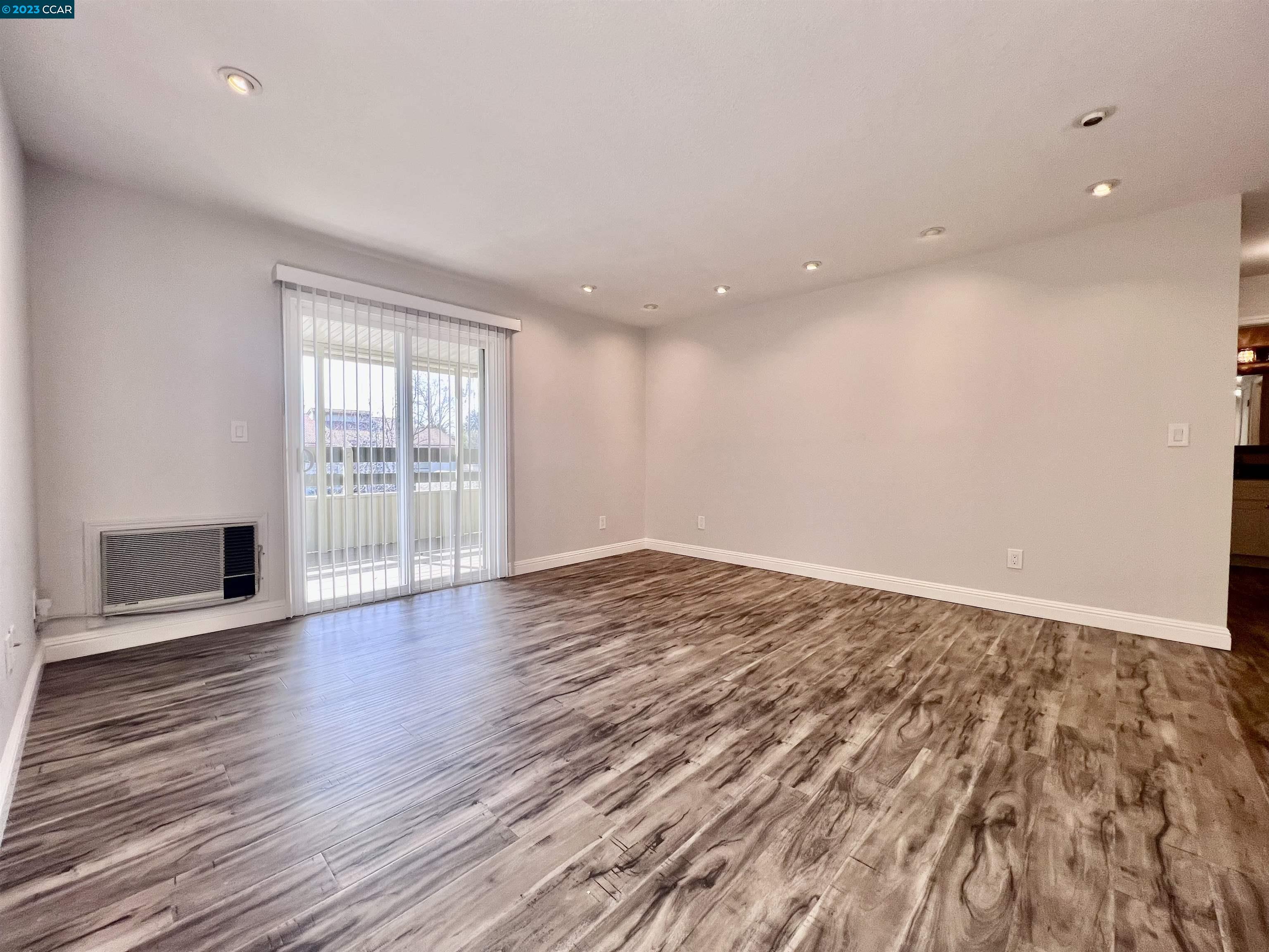 1505 Kirker Pass Road, Unit 239 Concord, CA 94521 - Photo 2 of 22 an empty room with wooden floor and windows