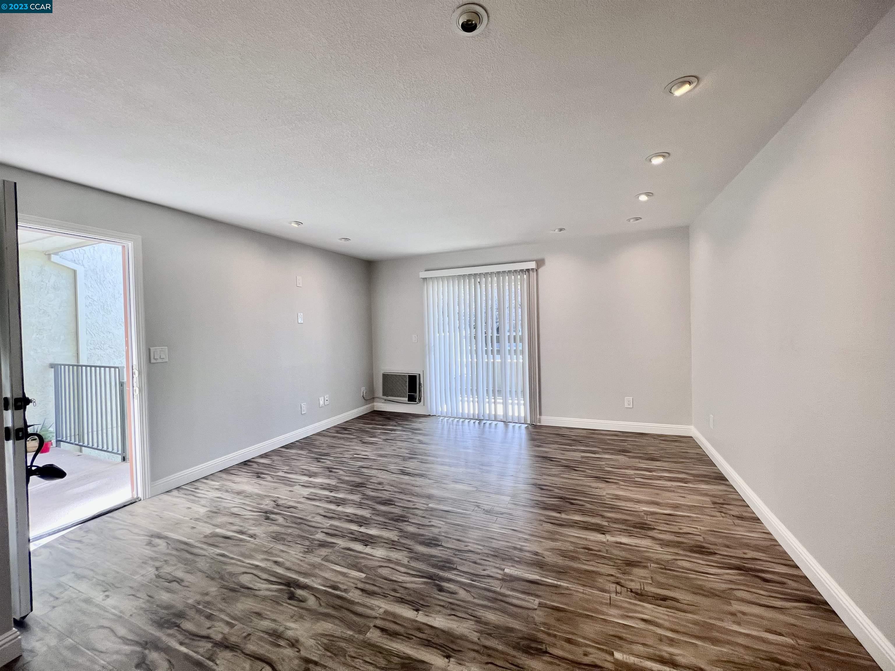 1505 Kirker Pass Road, Unit 239 Concord, CA 94521 - Photo 3 of 22 a view of an empty room with wooden floor
