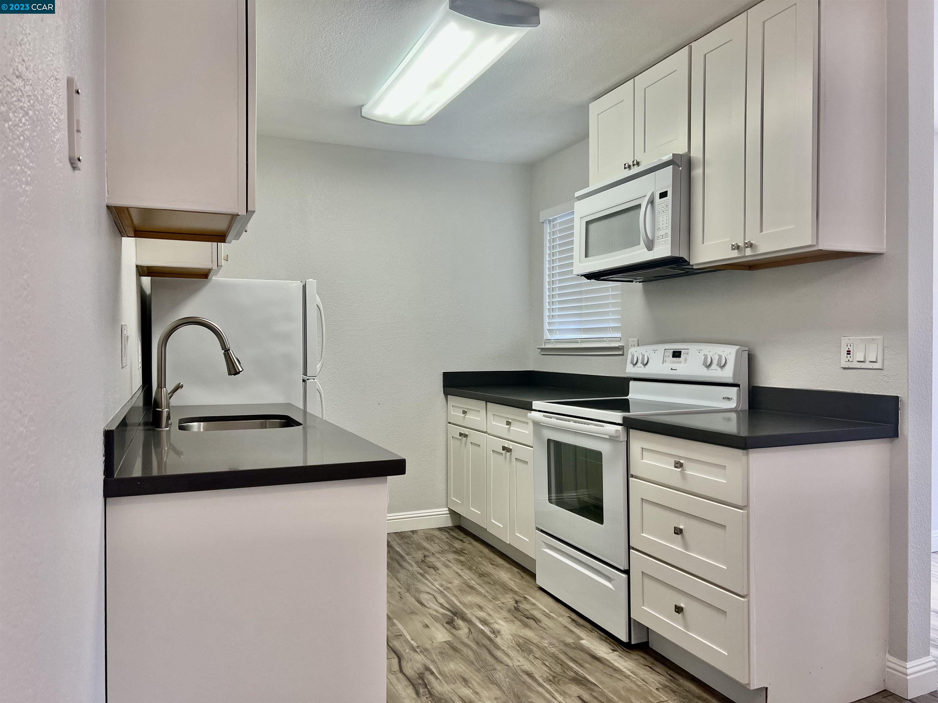 1505 Kirker Pass Road, Unit 239 Concord, CA 94521 - Photo 8 of 22 a kitchen with white cabinets and white appliances