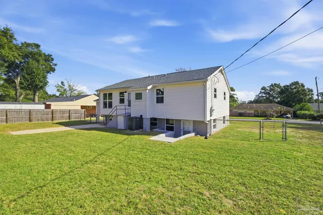 a view of a house with pool and a yard