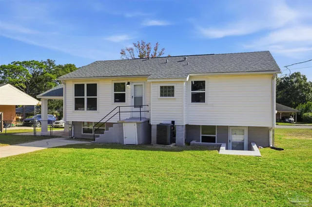 a front view of house with yard and outdoor seating