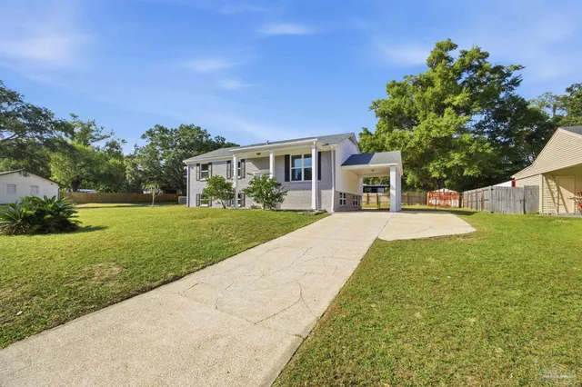 a view of house with yard