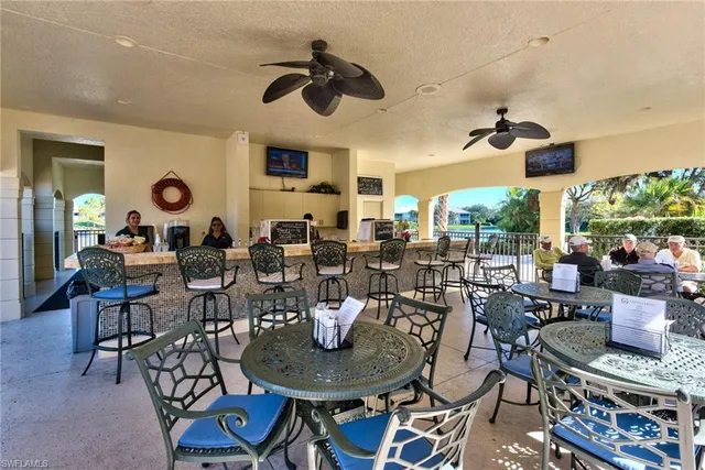 a living room with lots of furniture and view of kitchen