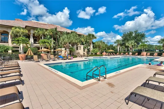 a view of a swimming pool and lounge chairs