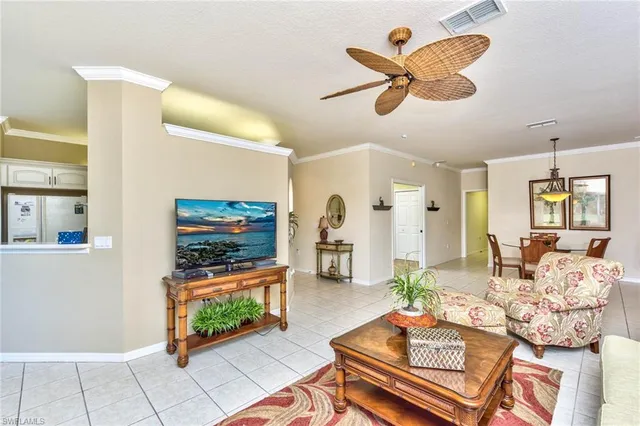 a living room with furniture a flat screen tv and a window