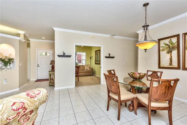 a dining room with furniture and a chandelier