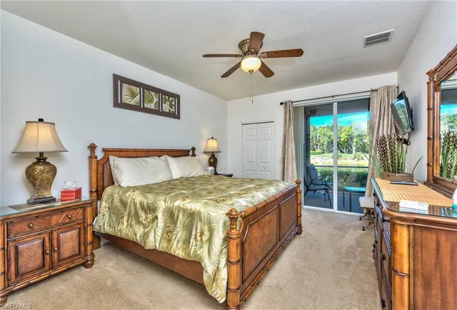 a bed sitting in a bedroom next to a window