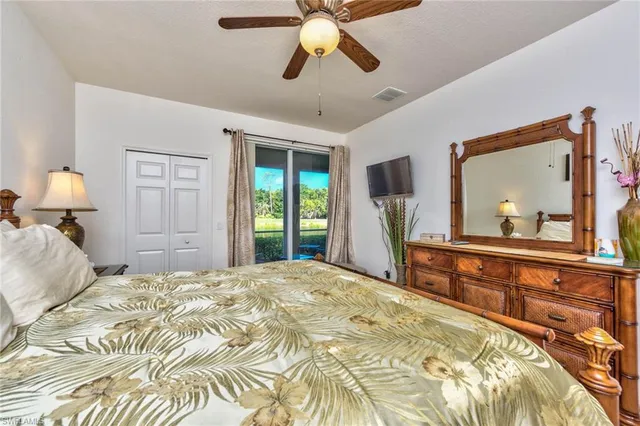 a bedroom with a bed and a large mirror with a flat tv screen