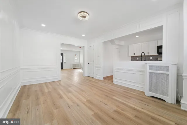 a view of a kitchen with wooden floor and a sink