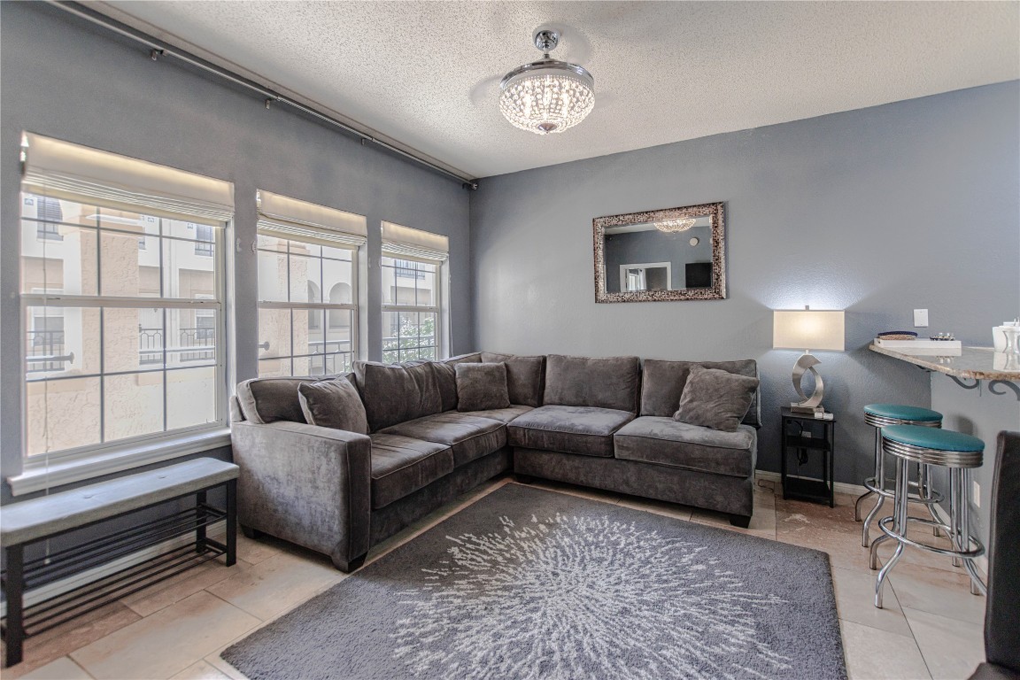 3404 American Drive, Unit 3226 Lago Vista, TX 78645 - Photo 12 of 40 a living room with furniture a chandelier and a window