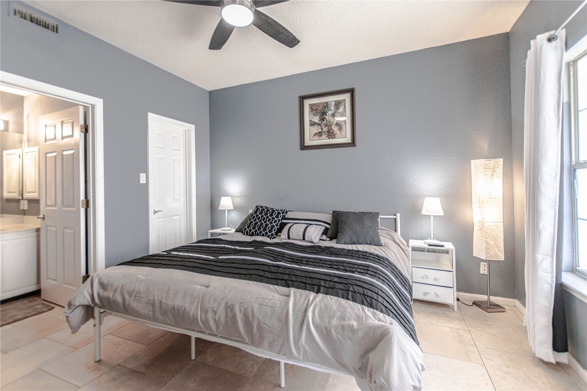 3404 American Drive, Unit 3226 Lago Vista, TX 78645 - Photo 18 of 40 a bedroom with a bed and a chandelier