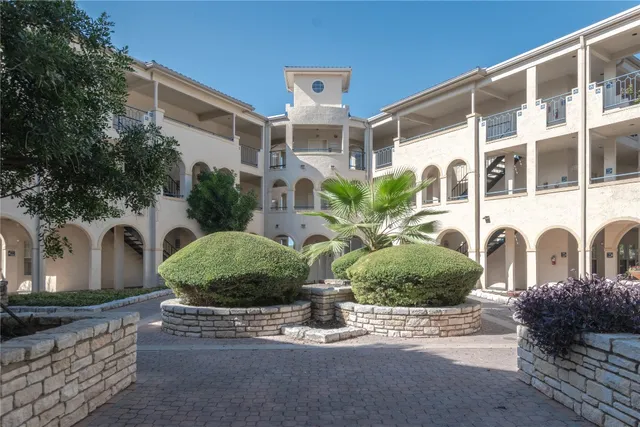a front view of a building with garden