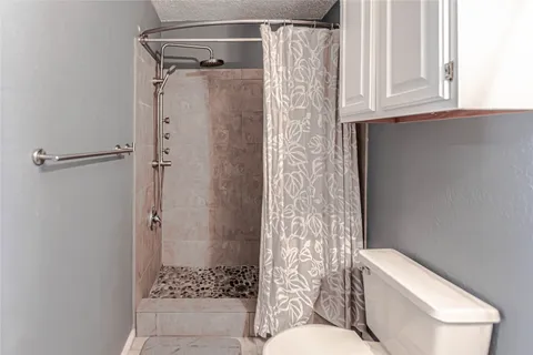 a bathroom with a toilet and shower