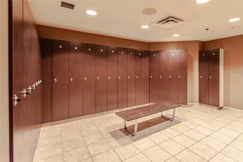 a spacious bathroom with a granite countertop sink a mirror and shower