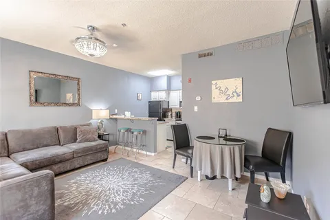 a living room with furniture and a mirror