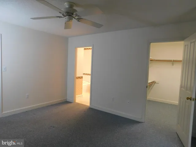 an empty room with a empty space and a ceiling fan