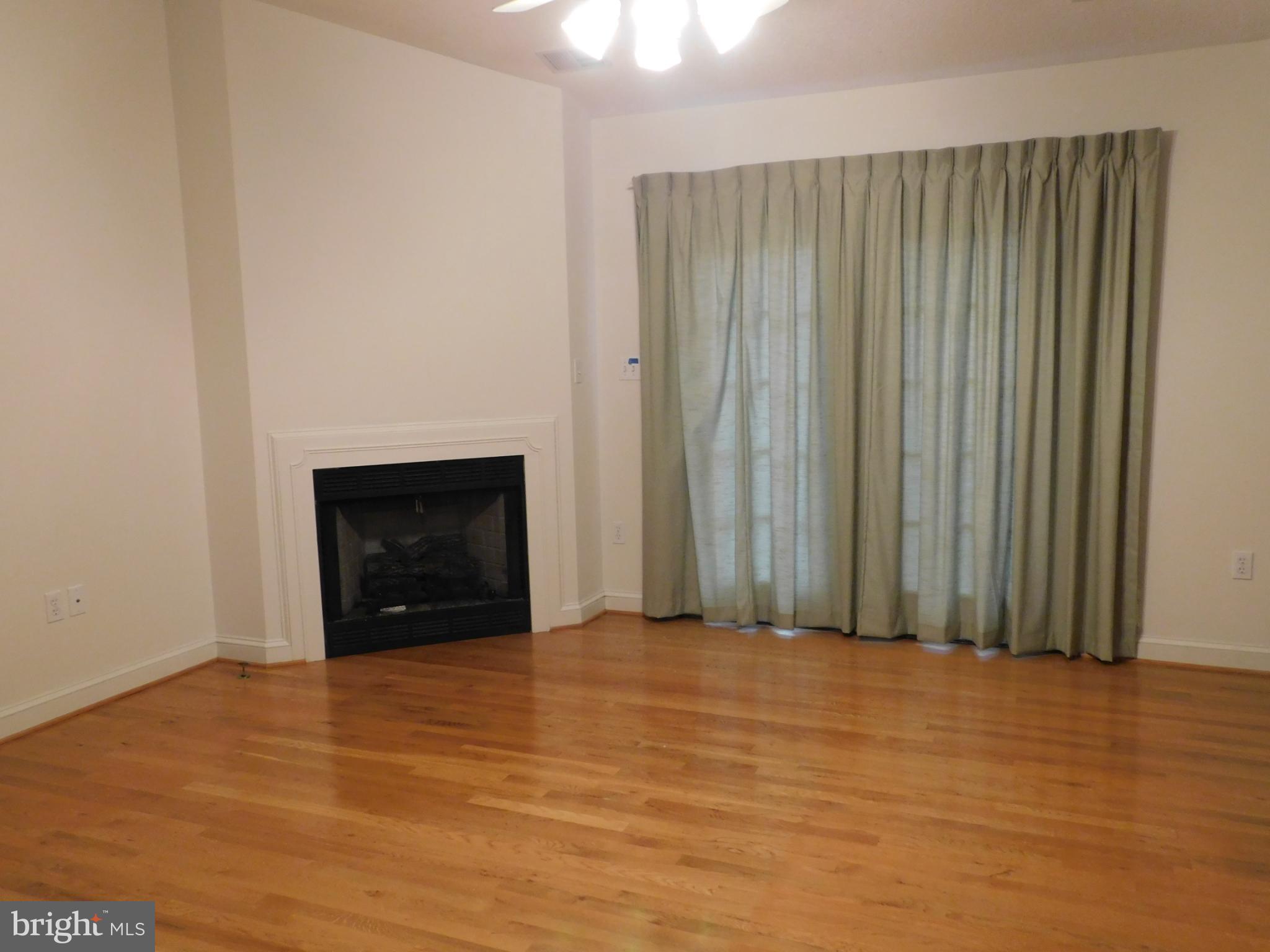 108 Senseny Glen Drive Winchester, VA 22602 - Photo 3 of 24 a view of an empty room with a fireplace and a window
