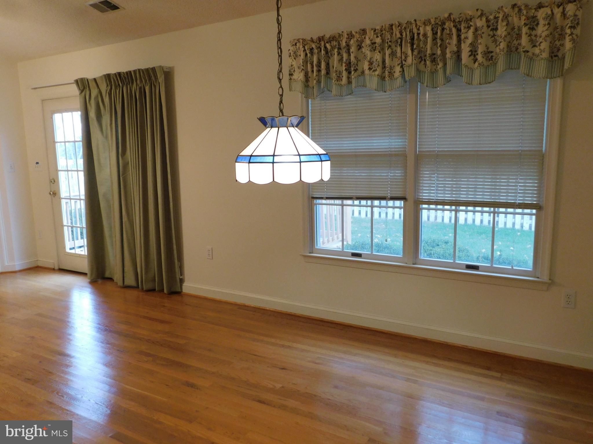 108 Senseny Glen Drive Winchester, VA 22602 - Photo 6 of 24 an empty room with wooden floor fan and windows