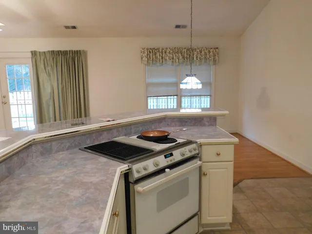 a kitchen with a stove and a window