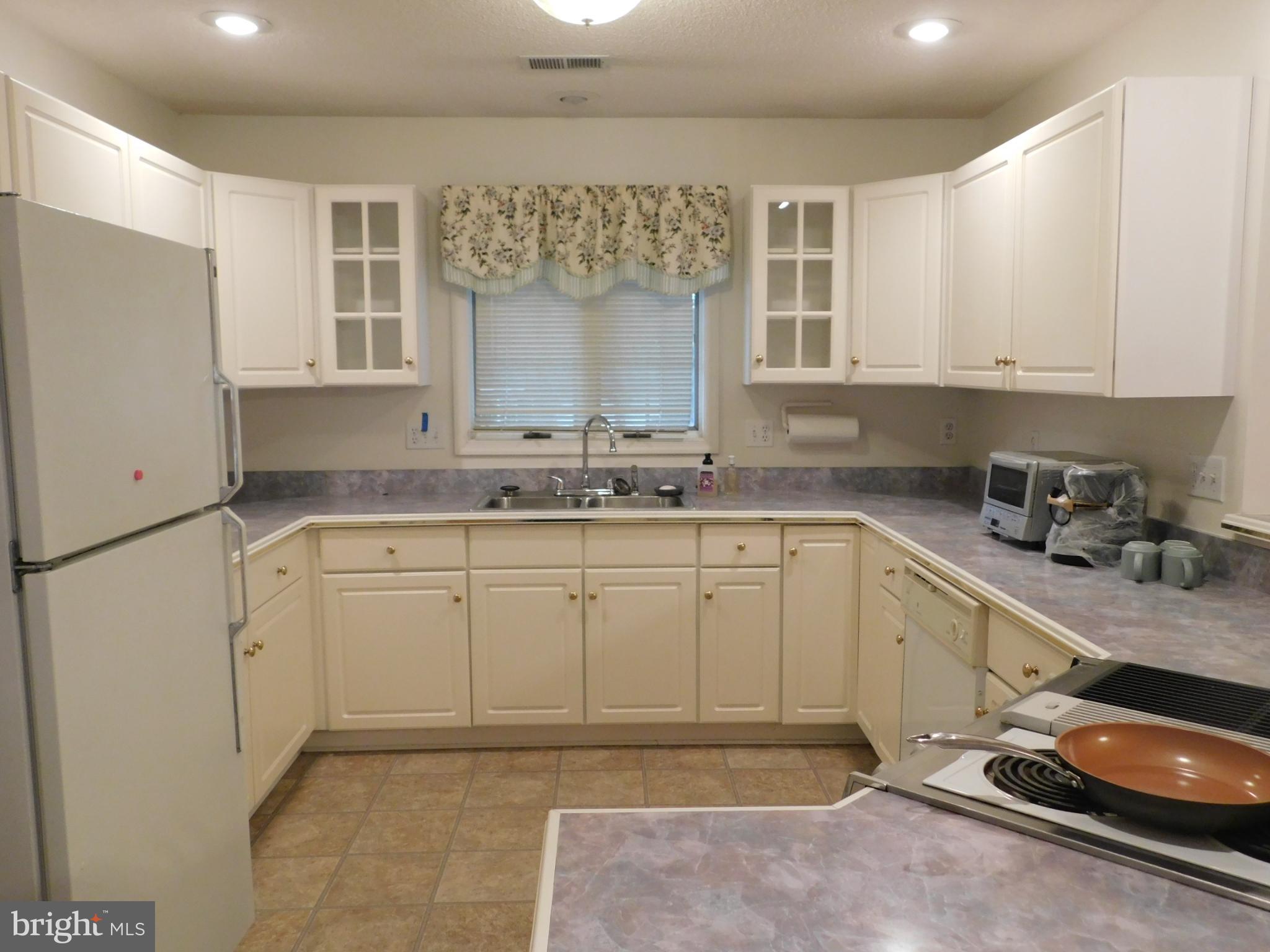 108 Senseny Glen Drive Winchester, VA 22602 - Photo 8 of 24 a kitchen with a sink stove and cabinets