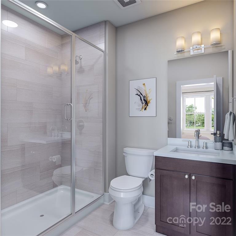 642 East Woodlawn Road Charlotte, NC 28209 - Photo 14 of 27 a bathroom with a granite countertop sink toilet and shower