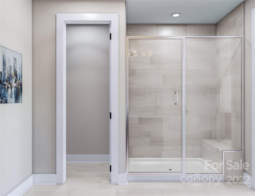 642 East Woodlawn Road Charlotte, NC 28209 - Photo 18 of 27 a bathroom with a glass shower door
