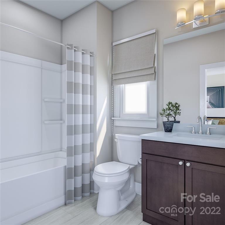 642 East Woodlawn Road Charlotte, NC 28209 - Photo 4 of 27 a bathroom with a sink toilet a mirror and shower