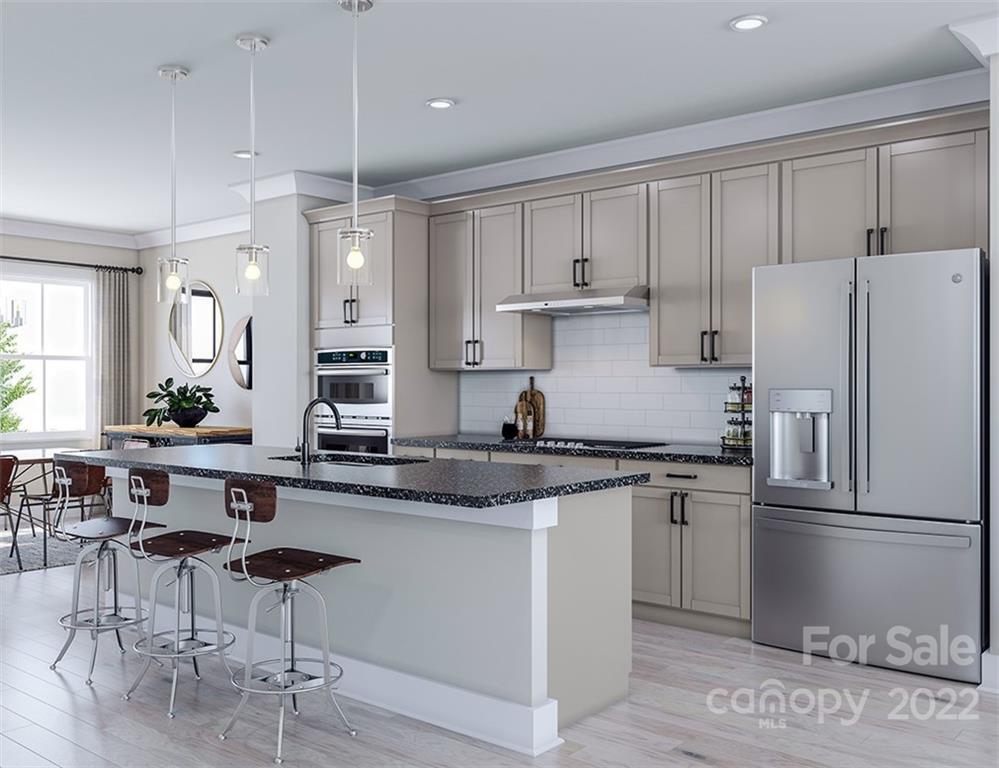 642 East Woodlawn Road Charlotte, NC 28209 - Photo 6 of 27 a kitchen with stainless steel appliances granite countertop a refrigerator a sink a stove a dining table and chairs