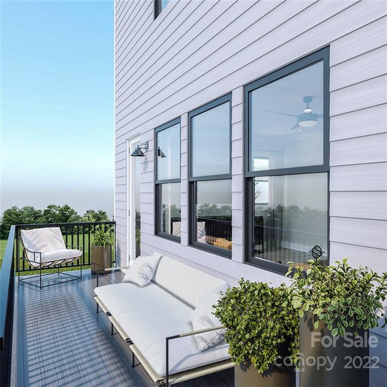 642 East Woodlawn Road Charlotte, NC 28209 - Photo 9 of 27 a balcony with furniture and a potted plant