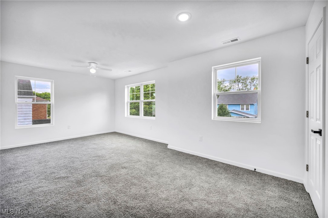 3709 Sudbury Road Cleveland, OH 44120 - Photo 14 of 29 Carpeted spare room with ceiling fan