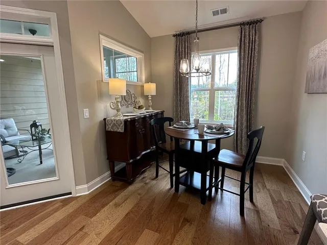 a view of a dining room with furniture window and wooden floor