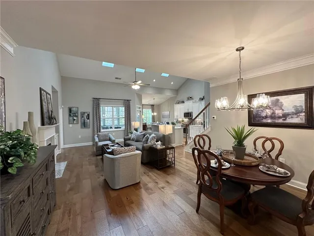 a view of a dining room with furniture wooden floor and chandelier