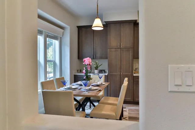a kitchen with kitchen island granite countertop a sink stainless steel appliances and white cabinets