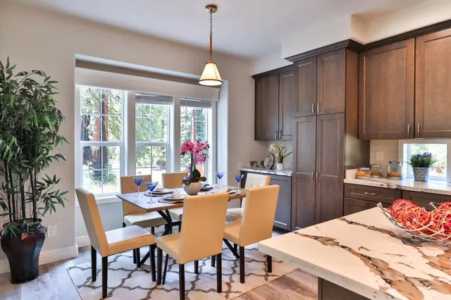 a kitchen with kitchen island granite countertop wooden cabinets and granite counter tops