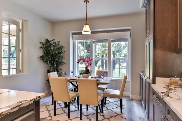 a kitchen with a dining table and chairs