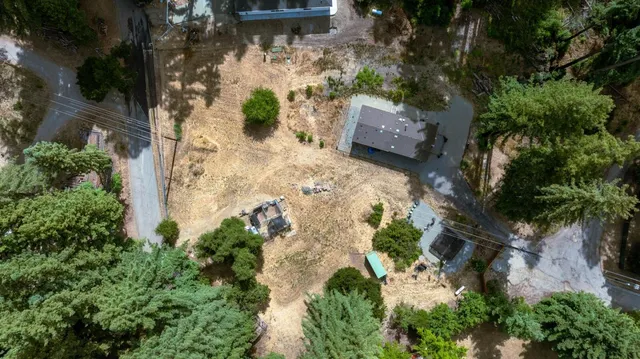 an aerial view of a house with a yard