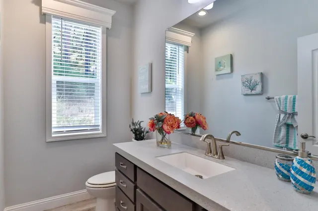 a front view of a house with a yard and trees