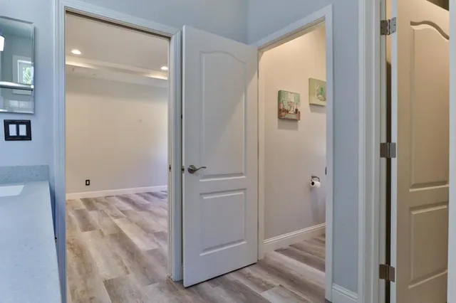 a front view of a house with a yard and trees