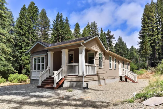 a view of a livingroom with a fireplace a fireplace and entryway