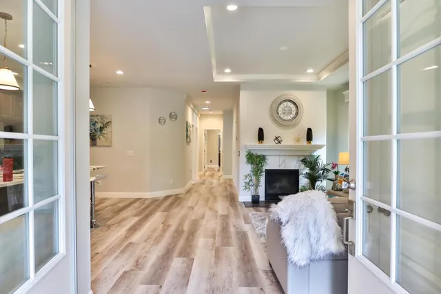 a living room with furniture a clock and a window