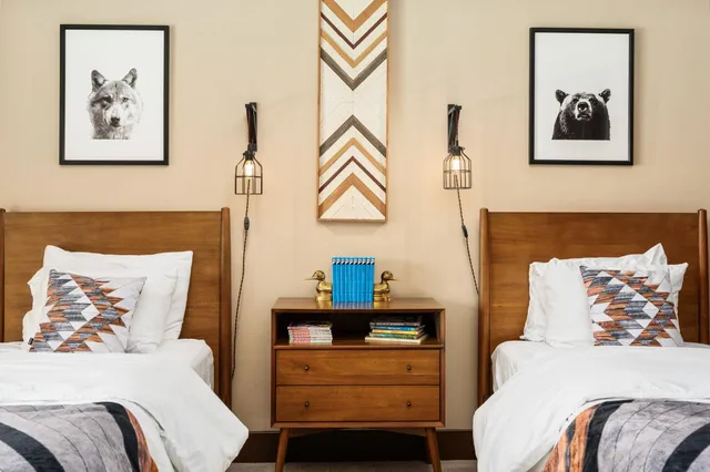 a bedroom with a bed and a painting on the wall