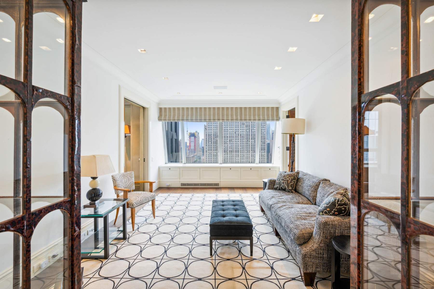 15 West 53rd Street, Unit 49BC Manhattan, NY 10019 - Photo 7 of 12 a living room with furniture and a window
