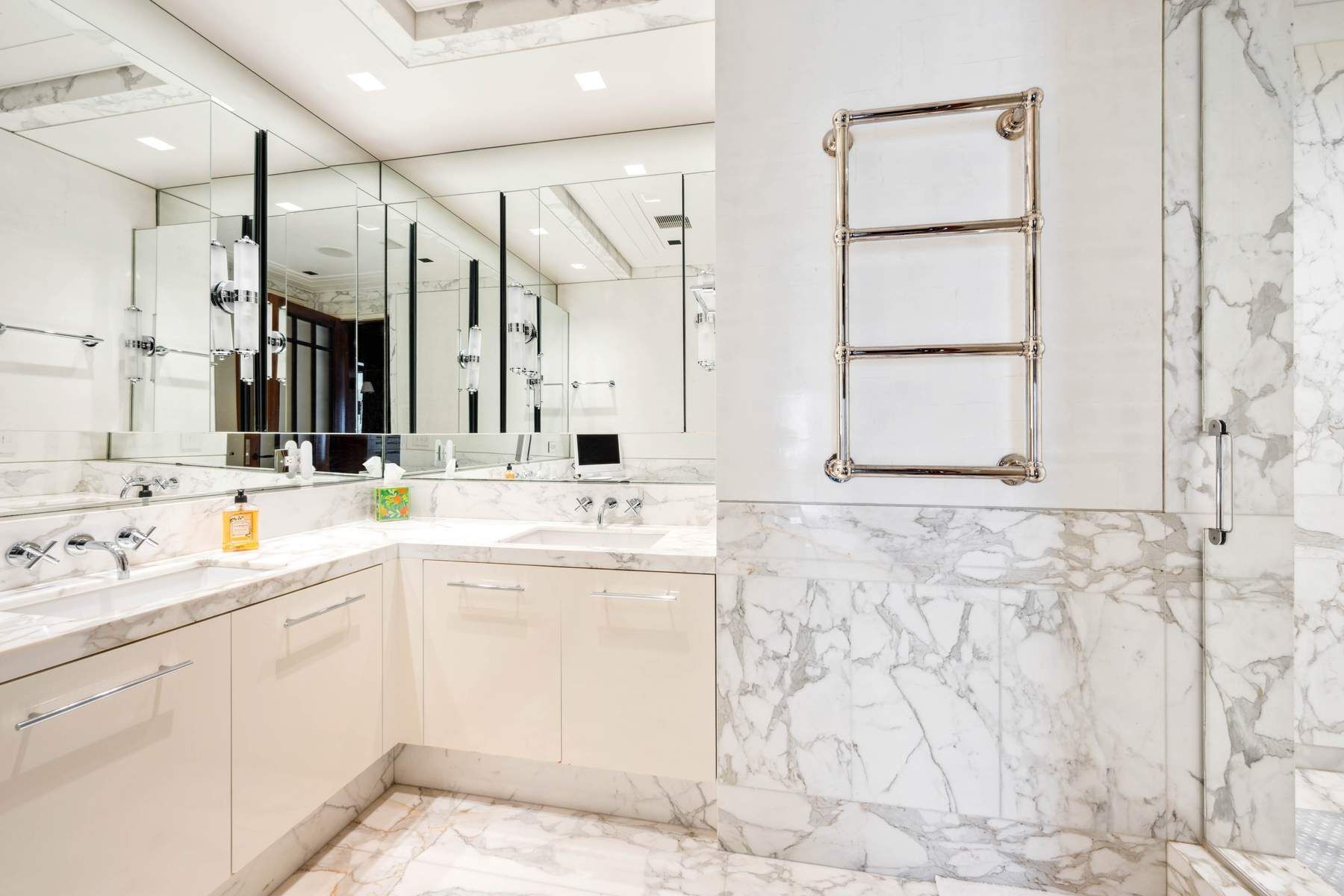 15 West 53rd Street, Unit 49BC Manhattan, NY 10019 - Photo 8 of 12 a bathroom with a sink and a mirror