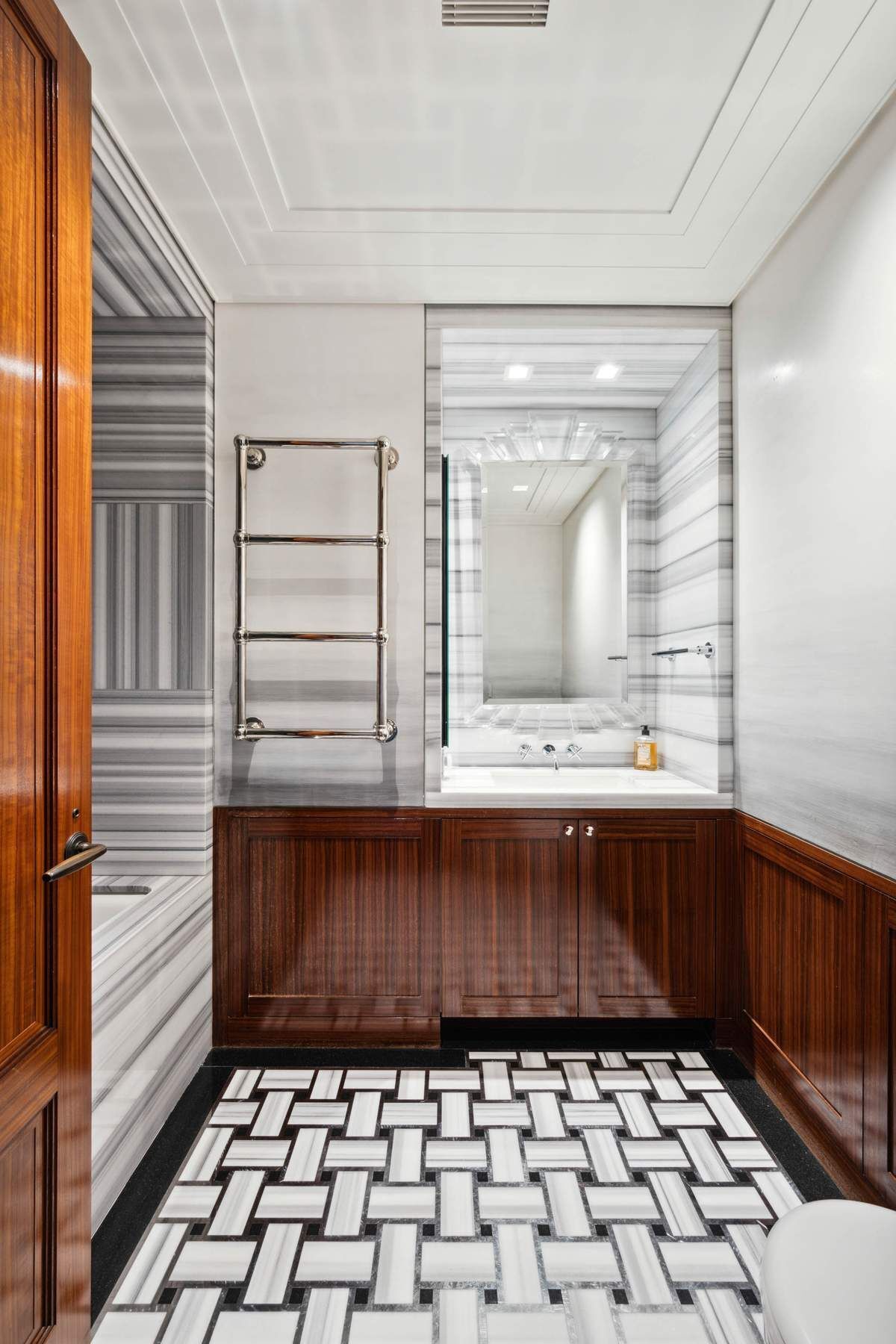 15 West 53rd Street, Unit 49BC Manhattan, NY 10019 - Photo 9 of 12 a bathroom with a sink a vanity and a mirror