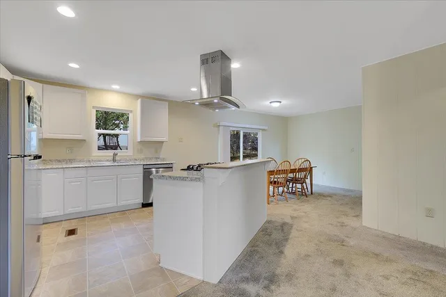 a kitchen with cabinets and window